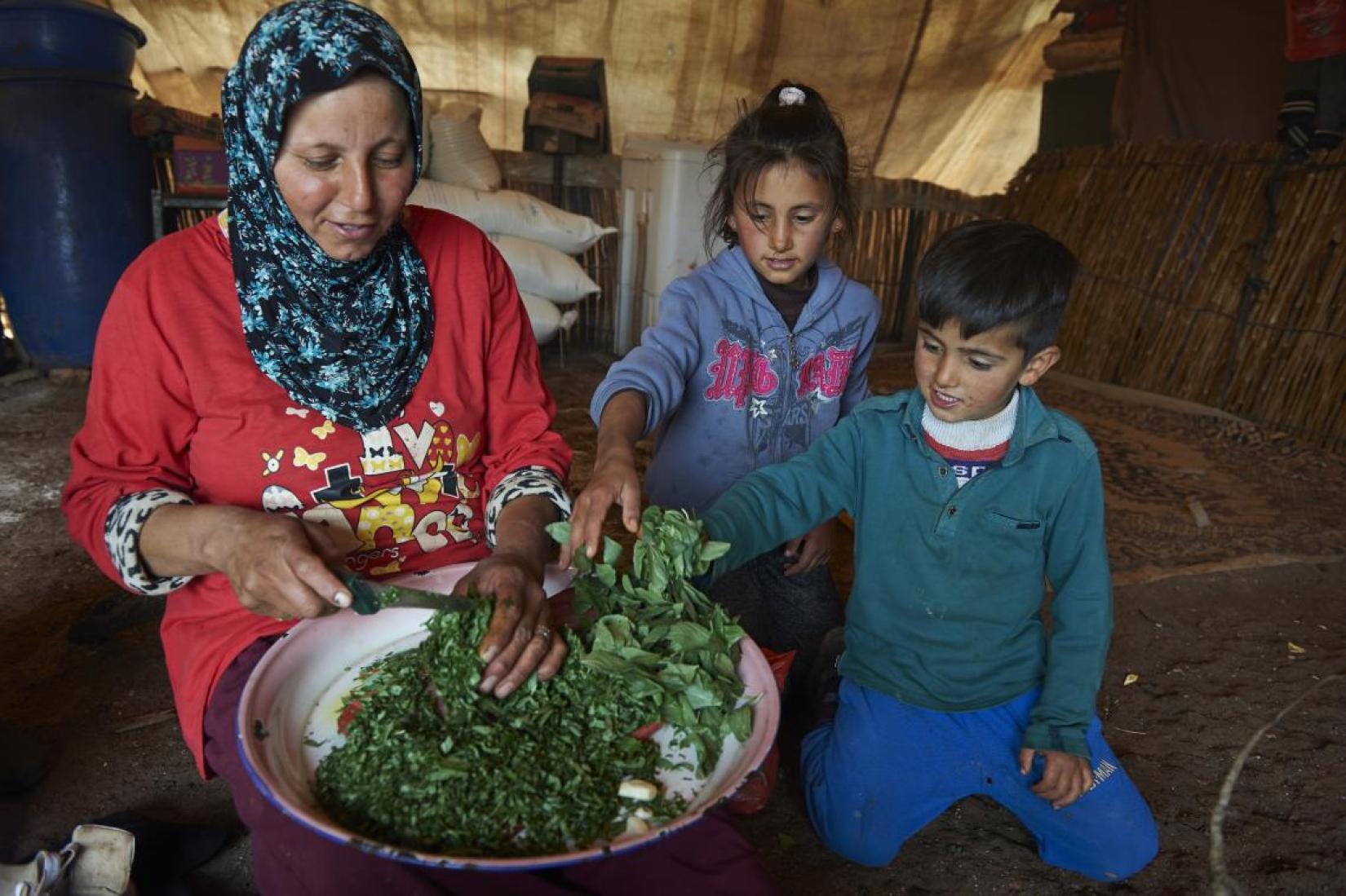 Mother making food for her children.